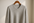 light-grey cashmere sweater on a coat hanger