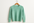 mint-green cashmere sweater on a coat hanger with white background