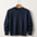 navy-blue cashmere sweater on a coat hanger with white background