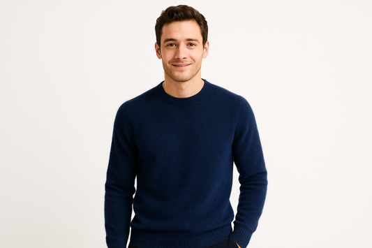 a young men wearing a  navy blue cashmere sweater with a white background