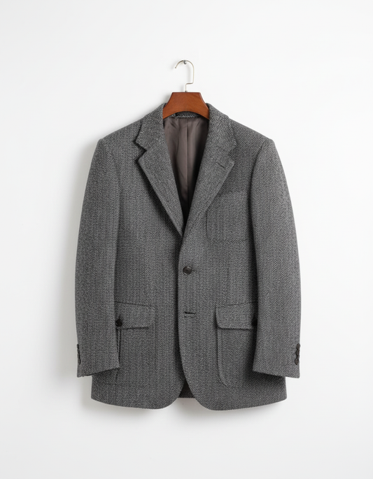 Charcoal gray herringbone tweed blazer on coat hanger