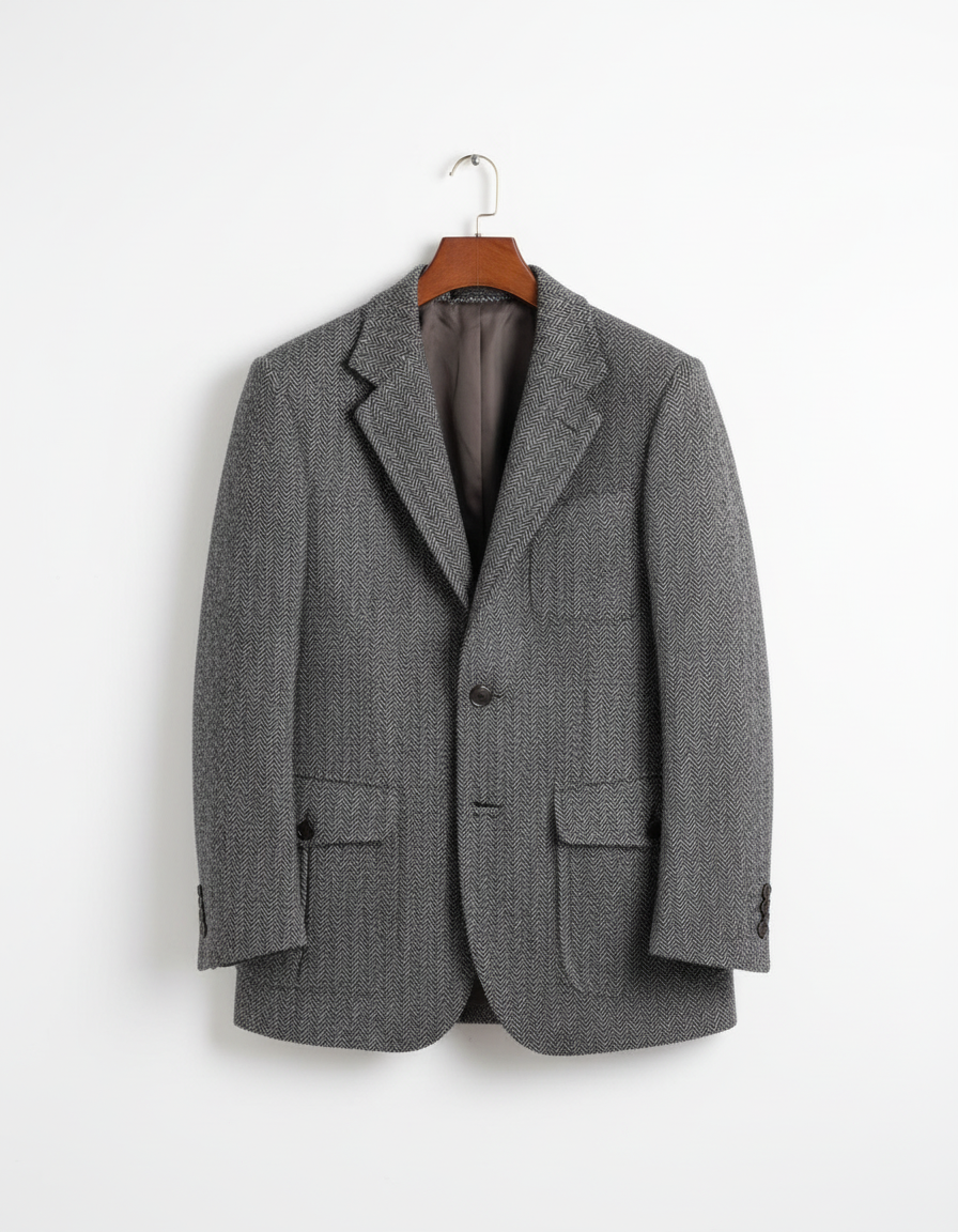 Charcoal gray herringbone tweed blazer on coat hanger