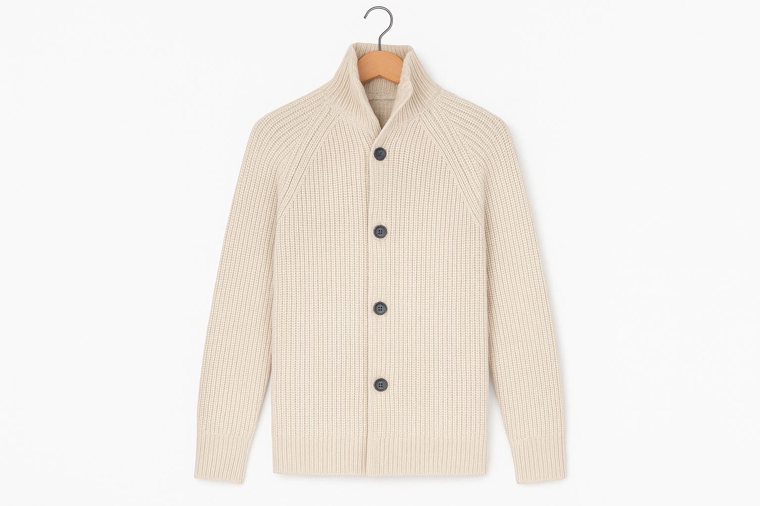 Cream beige ribbed knit cardigan hanging on coat hanger