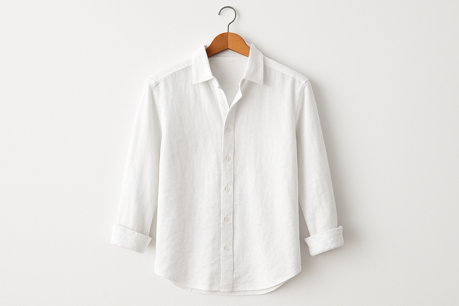 White linen button-up shirt on coat hanger