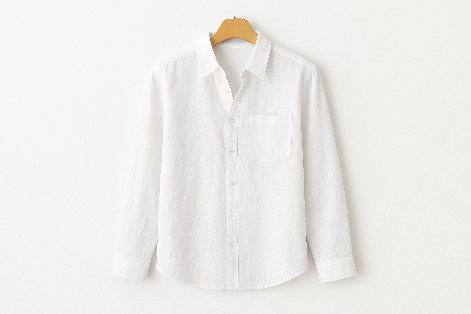 White linen button-up shirt on coat hanger